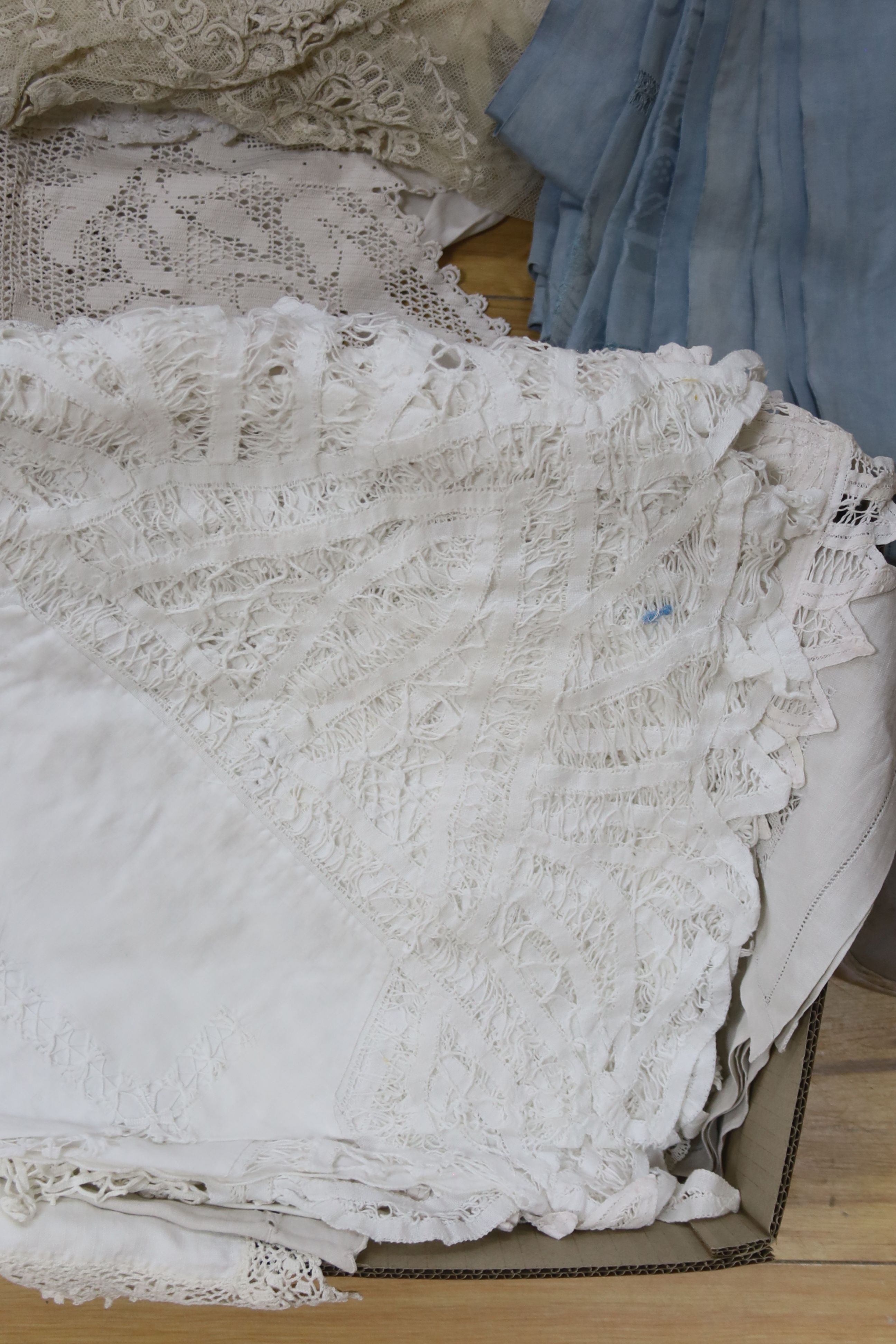 A large collection of table linen including drawn thread work, tape lace, cutwork and crochet cloths, mats. etc